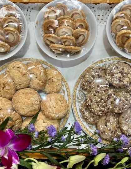 A platter of assorted homemade cookies. This selection includes melt-in-your-mouth French hearts, almond cookies, and healthy date seed cookies, perfect to accompany tea or coffee.