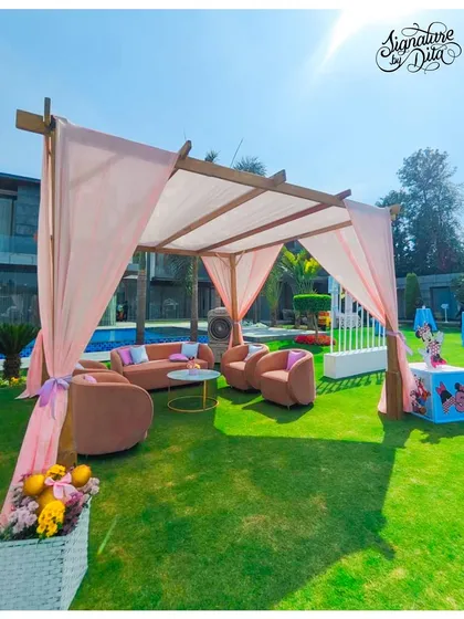 Another angle of the pastel pink Disneyland-themed lounge area, showing the elegant setup against the green lawn.