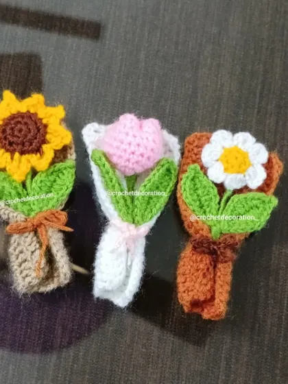 A trio of our extra-small (XS) bouquets: a sunflower, a pink tulip, and a white daisy. Each one is a tiny work of art.