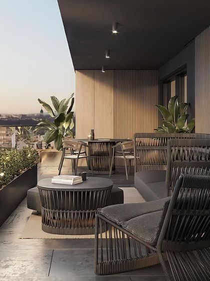Another perspective of the tropical-themed balcony, showing the dining and lounging areas. The design provides ample space for both relaxation and entertaining while connecting with the urban environment.