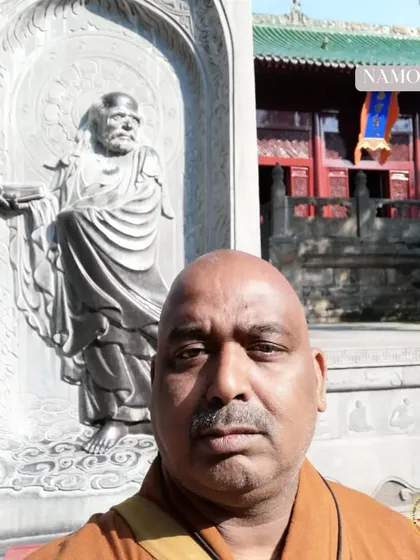 My journey began at the source. This is me at the Shaolin Temple in China, before a stone carving of Bodhidharma, the patriarch who brought Zen and martial arts to the temple. My teaching is rooted in this direct lineage.