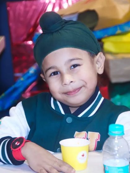 A charming portrait of a young Sikh boy smiling sweetly at the camera. We are experienced in capturing natural and engaging portraits of children of all ages.
