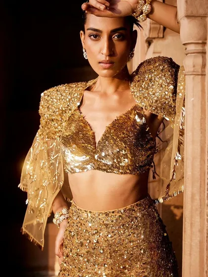 Embrace your inner radiance with this all-sequin ensemble. The dramatic puffed sleeves and dazzling gold texture are crafted for moments when you want to be the center of attention.