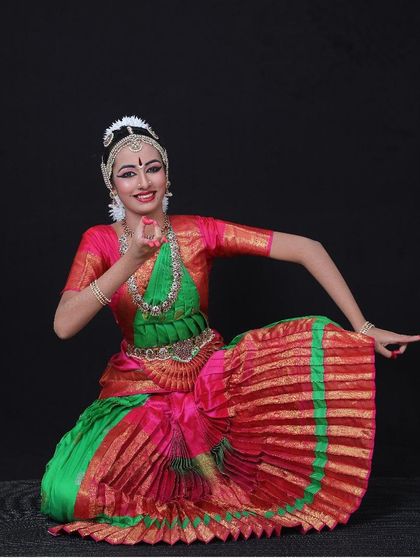 A beautiful portrait of a student in her full Arangetram attire, showcasing the intricate costume and jewelry.