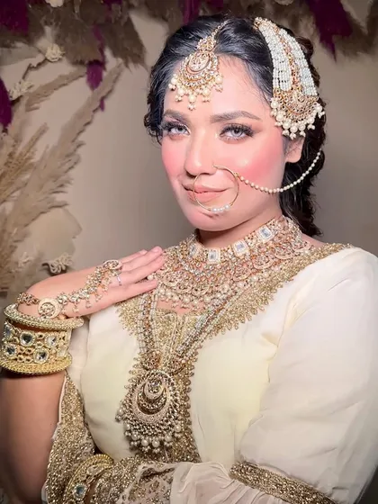 A portrait of the Nikkah bride, showing the complete look with the passa and heavy necklace.