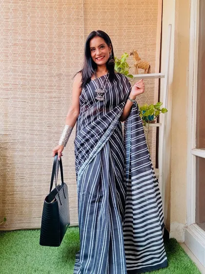 This black and white striped pre-stitched saree is a chic and timeless option. It's a go-to piece for a quick and stylish office look.