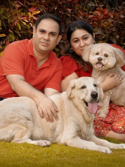 A complete family portrait. This shot brings everyone together, a happy couple with their Golden Retriever and Lhasa Apso mix, creating a memory they can cherish forever.