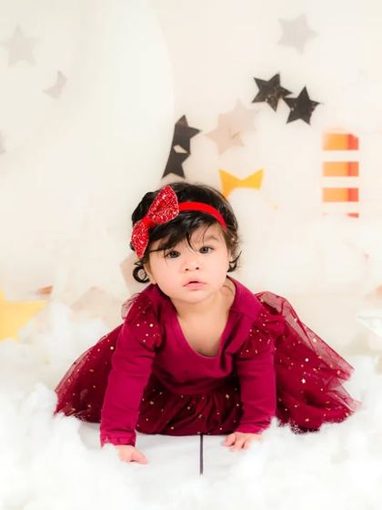 A baby girl crawls through a dreamy landscape of clouds and stars, on an adventure in her own imagination.