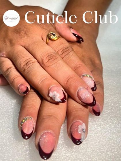 A deep wine-colored French manicure with a shimmery base. I added 3D white flowers and rhinestone details for a sophisticated and festive touch.