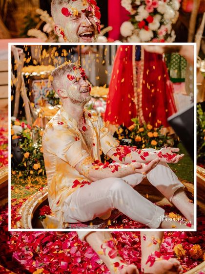 Another angle of the groom enjoying the flower shower, a key part of the vibrant Haldi we designed.