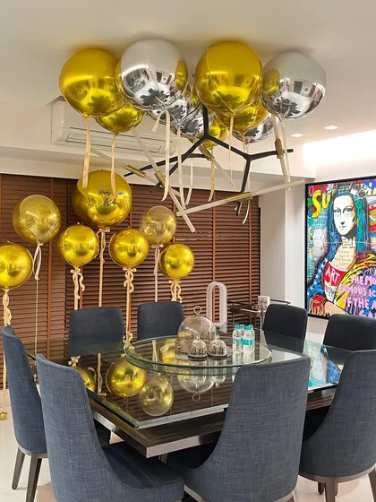 We filled this modern dining space with chic gold and silver orb balloons for Arjun Kapoor's birthday dinner, creating a festive yet sophisticated look.