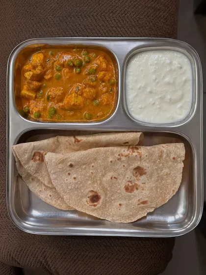 A classic North Indian meal of chapati, paneer peas curry, and curd. This is a simple, protein-rich, and satisfying vegetarian dish.