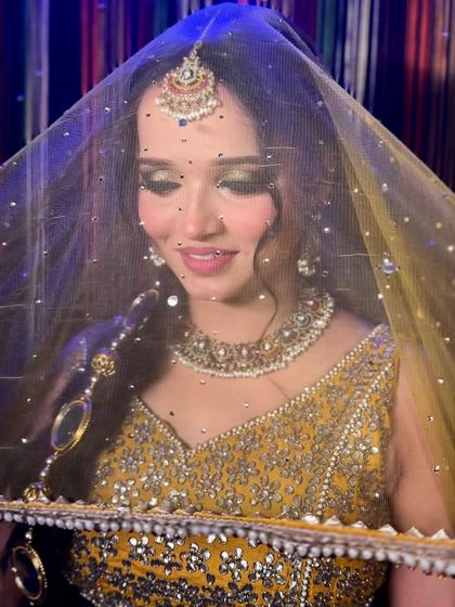 A final shot of the complete party look, with the dupatta framing her face. This shows how the entire look, from makeup to outfit, comes together.