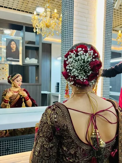A glimpse into my bridal hairstyling. This classic bridal bun, intricately woven and decorated with a combination of baby's breath and red roses, is the perfect finishing touch for a bride on her big day.