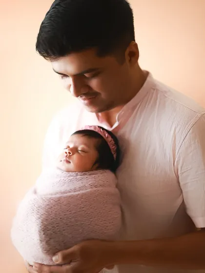 There is no place safer than a father's arms. The warmth and love in this portrait of a dad holding his sleeping baby is just beautiful.