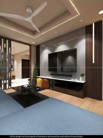 For clients who prefer a sophisticated living room setup, I design custom media walls. This example features a large-screen TV, an integrated soundbar, and elegant wood paneling with accent lighting to create a stylish focal point.