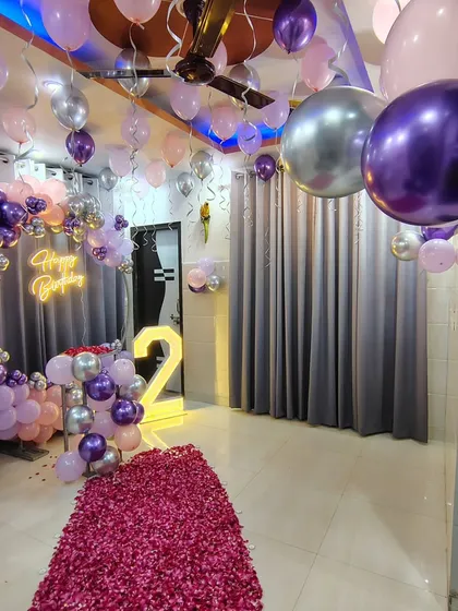 Another angle of the purple and silver birthday room decoration, showing the scale of the setup.