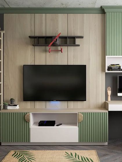 This kid's room is designed for play and study, with a TV unit, a computer desk, and a climbing wall. The green and wood-paneled design is modern and fun.