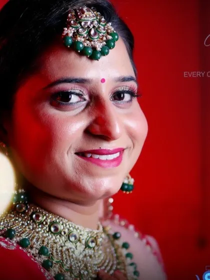 A colorful and happy portrait of a bride from a Punjabi wedding, perfect for an album cover or feature page.