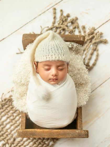 Minimalist and classy is what our newborn shoots are all about. A simple swaddle in a rustic wooden box creates a clean, timeless, and adorable portrait.