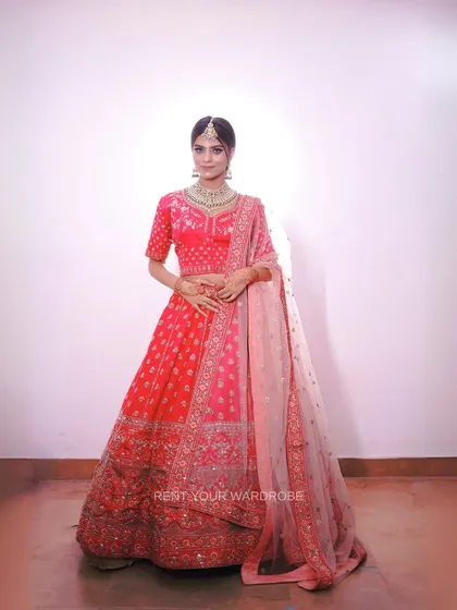 A full view of this elegant pink lehenga. The delicate embroidery and soft color make it a versatile choice for engagement or bridal looks.