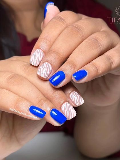 A full view of the bold blue and zebra stripe nail art set.