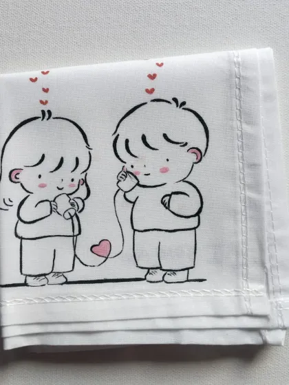 A hand-painted handkerchief showing a couple talking with a tin can phone. It's a nostalgic and sweet design that makes for a unique Valentine's or anniversary gift.