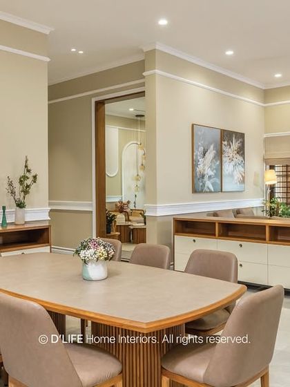 This spacious dining and living area is designed with a neutral palette and clean lines. Low-slung sideboards provide ample storage while maintaining a minimalist aesthetic.