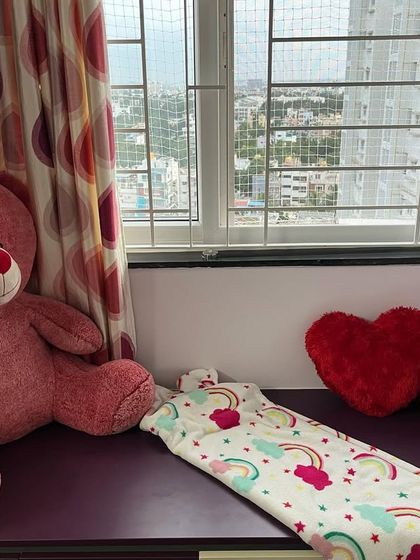 This cozy window seat was once a dumping ground for clutter. Now, it's a peaceful spot for a child to relax, read, and play. Creating these calm-down corners is a key part of making a room feel balanced and inviting.