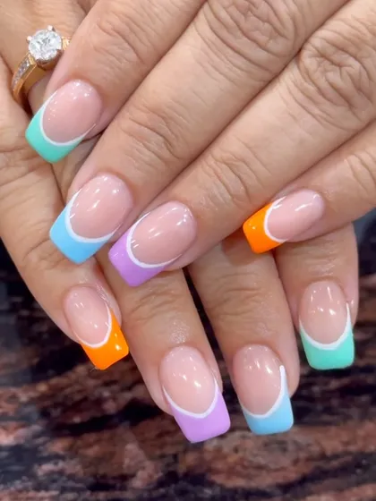A fun and colorful French manicure with each tip painted a different pastel color.
