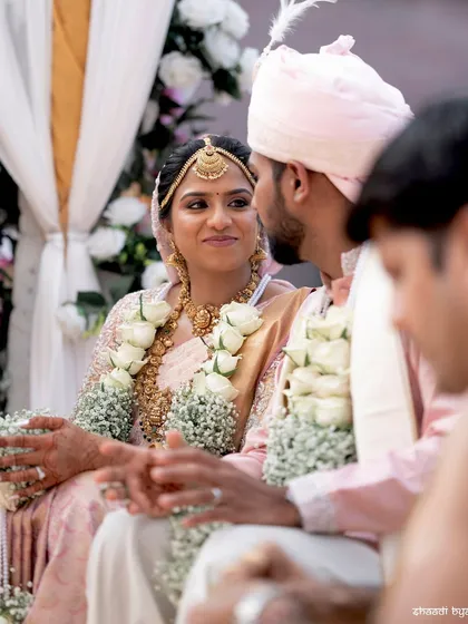 A moment from the wedding ceremony, with the bride and groom exchanging looks.