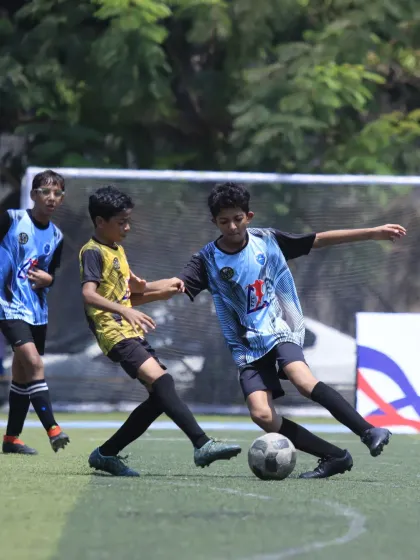 A tough tackle during the U-15 semi-final. Our player fights hard to win back possession, showcasing the grit and tenacity we value.