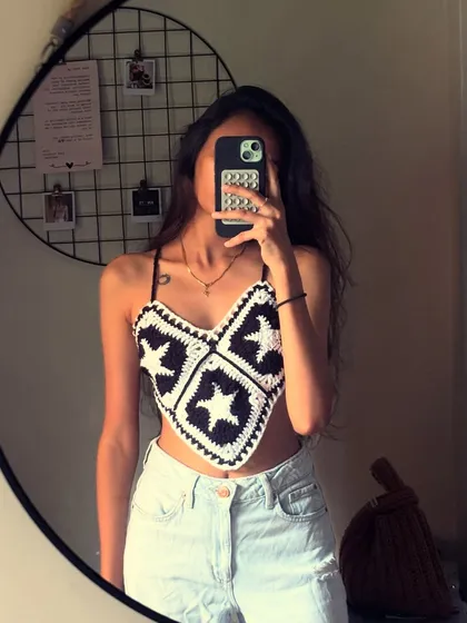 A mirror selfie moment with the star-patterned bandana top. It's made from individual granny squares that I stitch together to create the final piece.