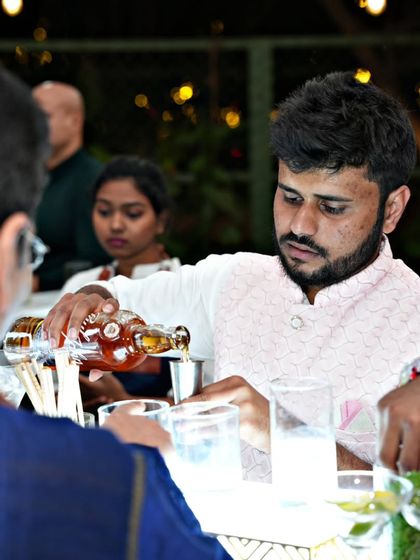 A close-up of our bartender carefully measuring and pouring a spirit for a custom cocktail. We pride ourselves on consistency and quality in every glass served at our events.