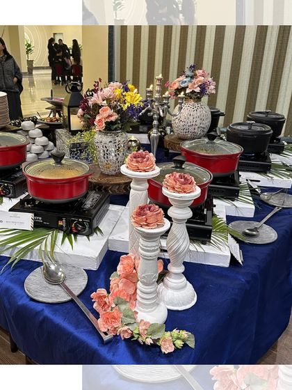 A beautiful buffet table with a royal blue theme. The setup is adorned with flowers and elegant candle holders, showcasing our attention to aesthetic detail.