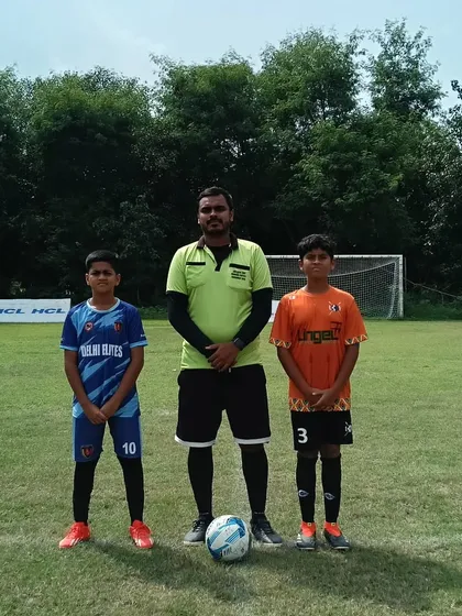 The captains meet at the center of the pitch before a U-13 HCL Youth League game.