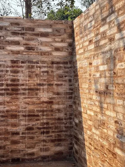 The warm, varied tones of the earth block walls are revealed in the sunlight. This material, made on-site, gives the building a character that is directly tied to its location.