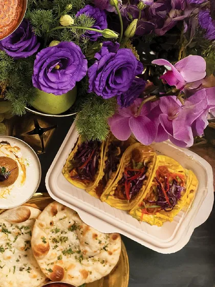 An assortment of dishes from our Diwali menu, including savory tacos and fresh naan, showcasing the variety within a single feast.
