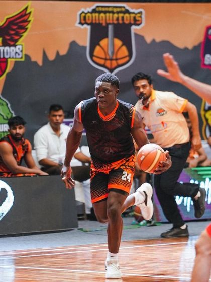 A player driving hard to the basket during an EPBL game. The intensity and focus required to compete at a professional level.