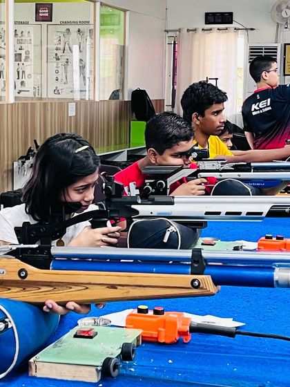 Young shooters engaged in a practice session, learning the fundamentals of rifle and pistol shooting in a safe and professional environment.