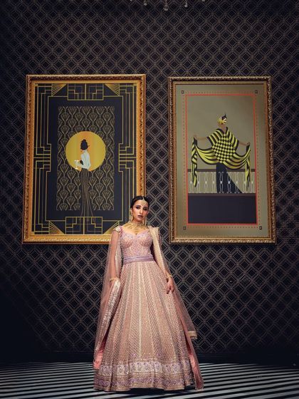 A full-length bridal shot in a luxurious setting, framed by art pieces. This composition adds a layer of sophistication and context, ideal for telling a story in a high-end bridal campaign.