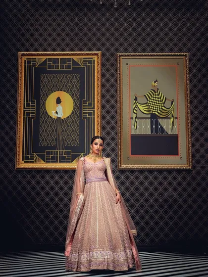 A full-length bridal shot in a luxurious setting, framed by art pieces. This composition adds a layer of sophistication and context, ideal for telling a story in a high-end bridal campaign.