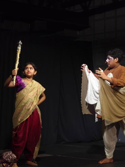 A dramatic moment captured on stage. Two young actors fully in character during their play, showcasing the acting and stage presence skills they developed during our children's theatre classes.