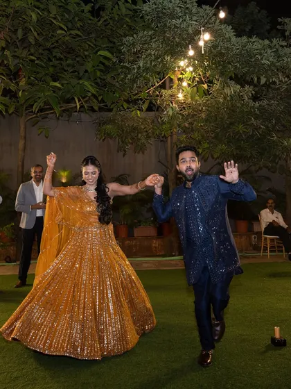 A fun, candid shot of the couple dancing at their outdoor sangeet.