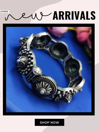 A beautifully detailed oxidized silver bangle with floral and dome motifs. This is a classic piece of tribal-inspired jewellery that is both bold and intricate.