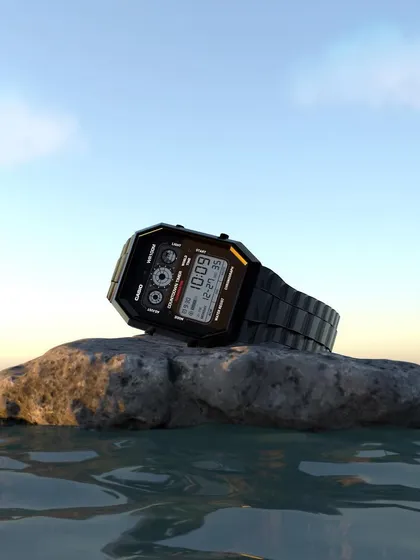 Another render of the Casio watch 3D model, this time set on a wet rock at the water's edge during sunset. This demonstrates how lighting and environment can completely change the mood of a product visualization.