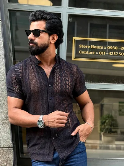 Another angle of the black knitted mesh shirt, highlighting its unique texture and modern design.
