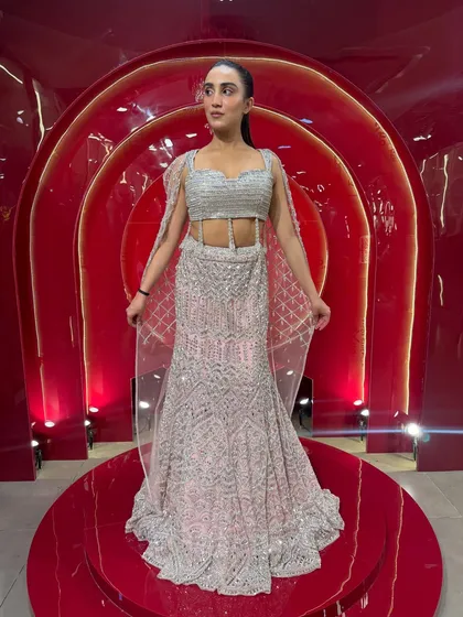A front view of the 'Indian Barbie' lehenga, showing the beautiful cut and the delicate sheer cape. This rental designer piece is perfect for making a statement.