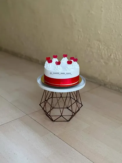 A simple and sweet cake with red hearts, perfect for expressing your love.