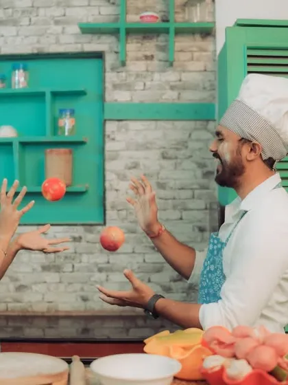 Love is cooking up something beautiful! This couple shares a laugh in a quirky kitchen setting, a perfect example of a themed pre-wedding shoot that reflects shared interests and creates fun, natural interactions.